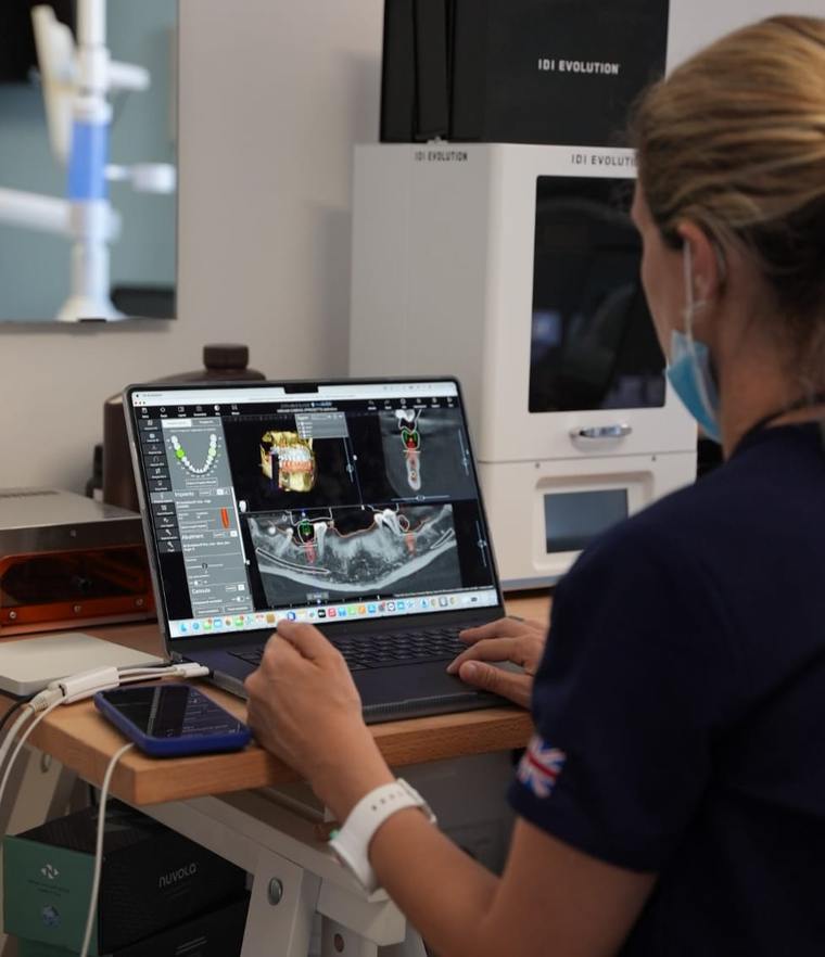Dr Annapaola Dessì planning dental implant treatment on a 3D scan in her Cagliari practice